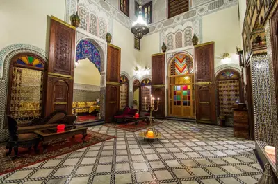 a living room with a large room with a large room at Riad Ibn Khaldoun in Fès
