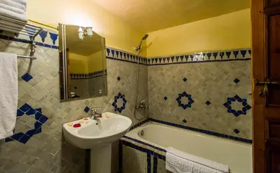 a bathroom with a sink and a bath tub at Riad Ibn Khaldoun in Fès