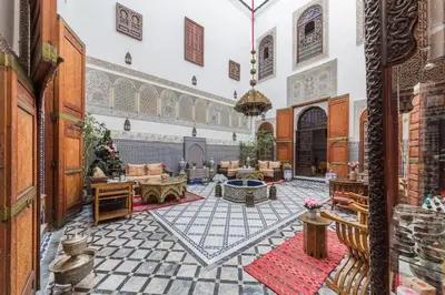 a living room filled with furniture in a building at Riad Ghita in Fès