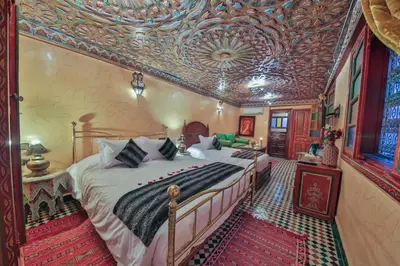a bedroom with a bed in a room with a ceiling at Riad Ghita in Fès