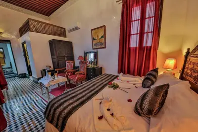 a bedroom with a large bed with towels on it at Riad Ghita in Fès