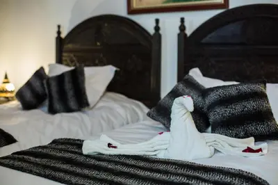 a pile of towels sitting on top of a bed at Riad Ghita in Fès