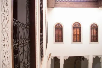 a group of windows on a white building at Riad Jamaï in Fès