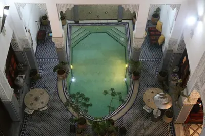 an overhead view of a swimming pool in a building at Riad Jamaï in Fès