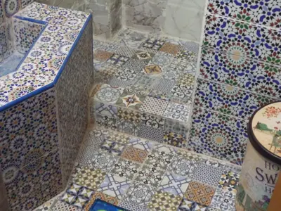 a bathroom with mosaics on the floor of a room at Dar Nouzha A in Fès