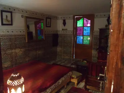 a room with a bed and stained glass windows at Dar Nouzha A in Fès