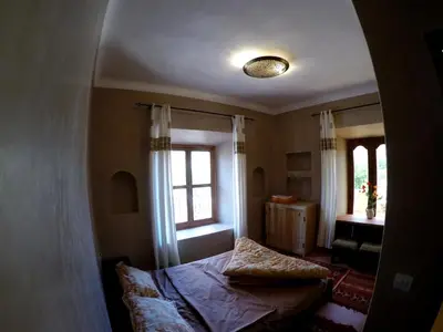 a bedroom with a bed and a window at La Kasbah du M'goun in Timit