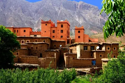 a group of buildings in front of a mountain at La Kasbah du M'goun in Timit