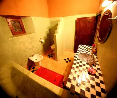 a bathroom with a lego bathroom with a tub and a sink at Riad Maktoub in Aït Ben Haddou