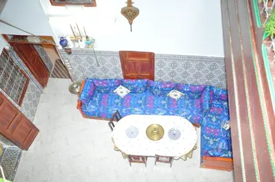 an overhead view of a living room with a blue couch at La Colombe Blanche in Moulay Idriss Zerhoun