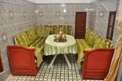 a living room with a couch and a table at La Colombe Blanche in Moulay Idriss Zerhoun
