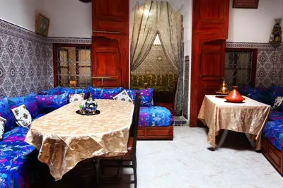 a living room with a table and a couch at La Colombe Blanche in Moulay Idriss Zerhoun
