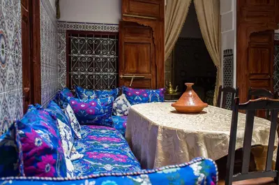 a room with a table and a vase on a couch at La Colombe Blanche in Moulay Idriss Zerhoun