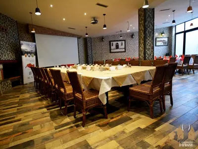 a large dining room with a long table and chairs at L'empreinte D'ifrane in Ifrane