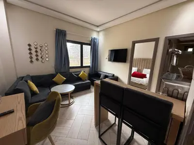 a living room with a couch and a mirror at L'empreinte D'ifrane in Ifrane