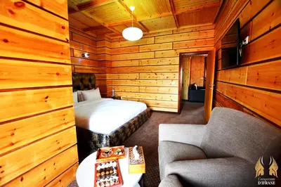 a bedroom with a bed and a couch and a chair at L'empreinte D'ifrane in Ifrane