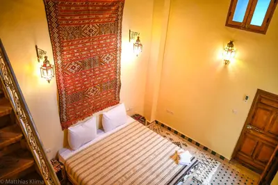 a small bedroom with a bed in a room at Medina social club in Fès