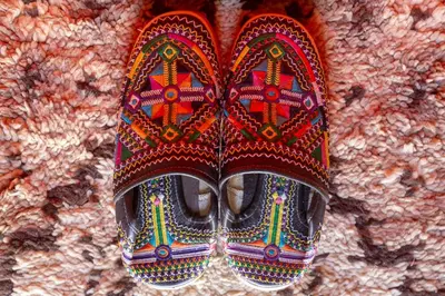 a pair of shoes sitting on top of a wall at Sahara Desert Luxury Camp in Merzouga