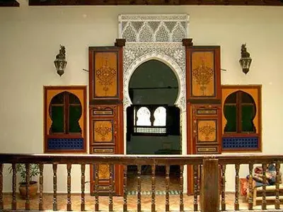 a room with a gate and a door in a building at Ryad Bahia in Meknès