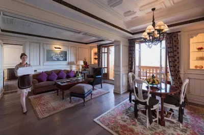 a woman is standing in a living room at Michlifen Resort & Golf in Ifrane