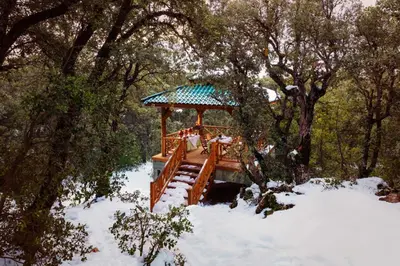 a gazebo with people sitting in it in the snow at Michlifen Resort & Golf in Ifrane