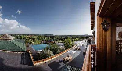 a view from the balcony of a resort with a pool at Michlifen Resort & Golf in Ifrane