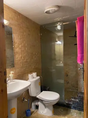 a bathroom with a toilet and a sink and a shower at dar hassbia in Fès