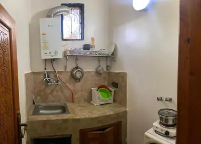 a kitchen with a sink and a counter top at dar hassbia in Fès