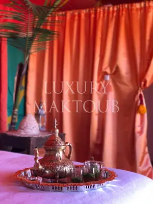 a tea pot on a plate on a table at Luxury Maktoub in Merzouga