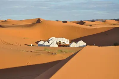 a building in the middle of a desert at Luxury Maktoub in Merzouga