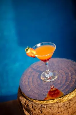 a drink in a glass sitting on a plate at Hotel Kasbah Sahara Services - M'Hamid El Ghizlane in Mhamid