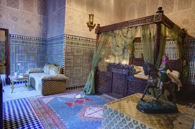 a bedroom with a canopy bed and a table at Riad Salam Fes & Spa in Fès