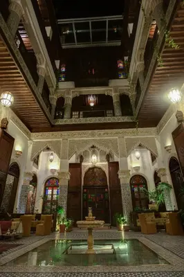 a lobby with a fountain in the middle of a building at Riad Salam Fes & Spa in Fès