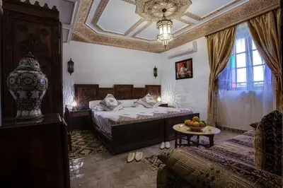 a bedroom with a bed and a table with fruit on it at Riad Salam Fes & Spa in Fès