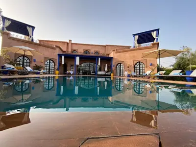 a swimming pool in front of a building at Villa TYCOZ in Marrakech