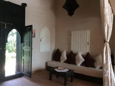 a living room with a couch and a table at Villa TYCOZ in Marrakech