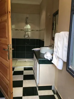 a bathroom with a sink and a shower with a counter at Villa TYCOZ in Marrakech