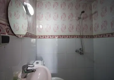 a bathroom with a sink and a shower at Hôtel Fontaine Campini in Fès