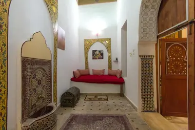 a room with a red bench in a room at Riad Diwan in Fès