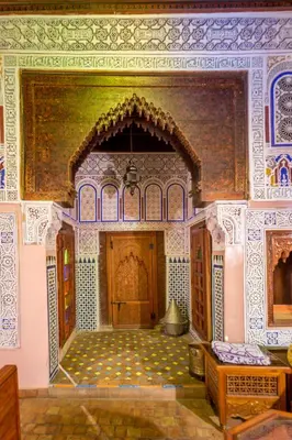 an ornate room with a building with a large doorway at Riad Hiba in Meknès
