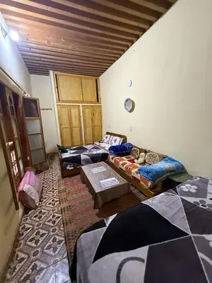 a room with three beds in a room at Dar Elkorchi in Fès