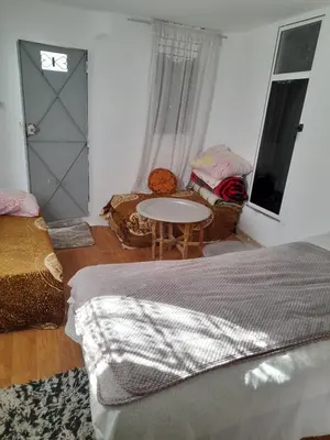 a bedroom with a bed and a table and chairs at Dar Elkorchi in Fès