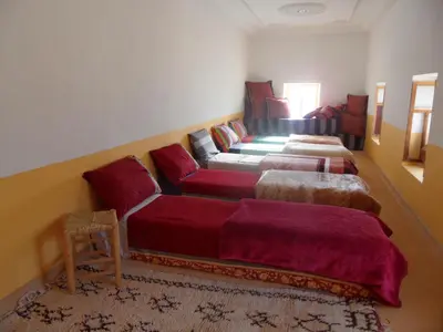 a living room with two beds and a couch at Gite Tigmi Azrur in Tabant