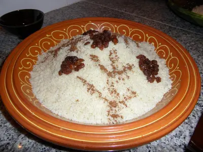 a cake on an orange plate on a table at Gite Tigmi Azrur in Tabant