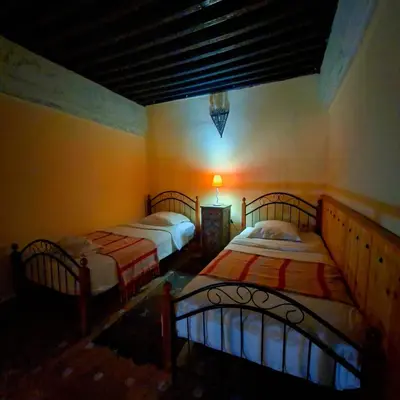 a bedroom with two beds in a room at Riad Menthe Et Citron in Meknès