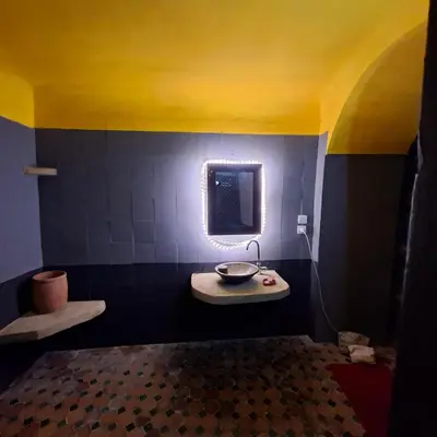 a bathroom with a sink and a mirror at Riad Menthe Et Citron in Meknès