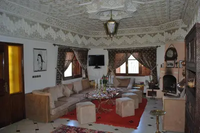 a living room with a couch and a table at Riad Villa Midelt in Midelt