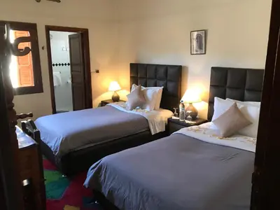 a hotel room with two beds and two lamps at Riad Villa Midelt in Midelt