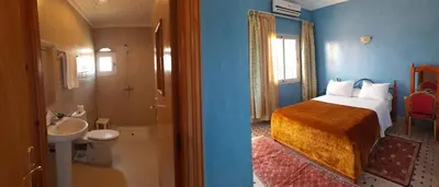 a bedroom with a bed and a bathroom with a sink at Hotel Marmar in Ouarzazate