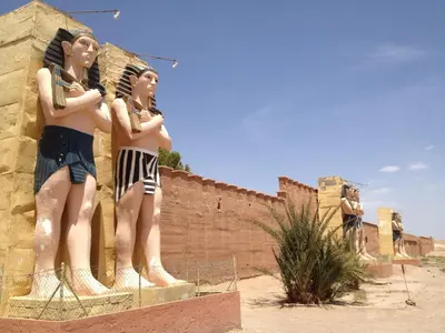 a statue of two girls standing next to a wall at Hotel Marmar in Ouarzazate